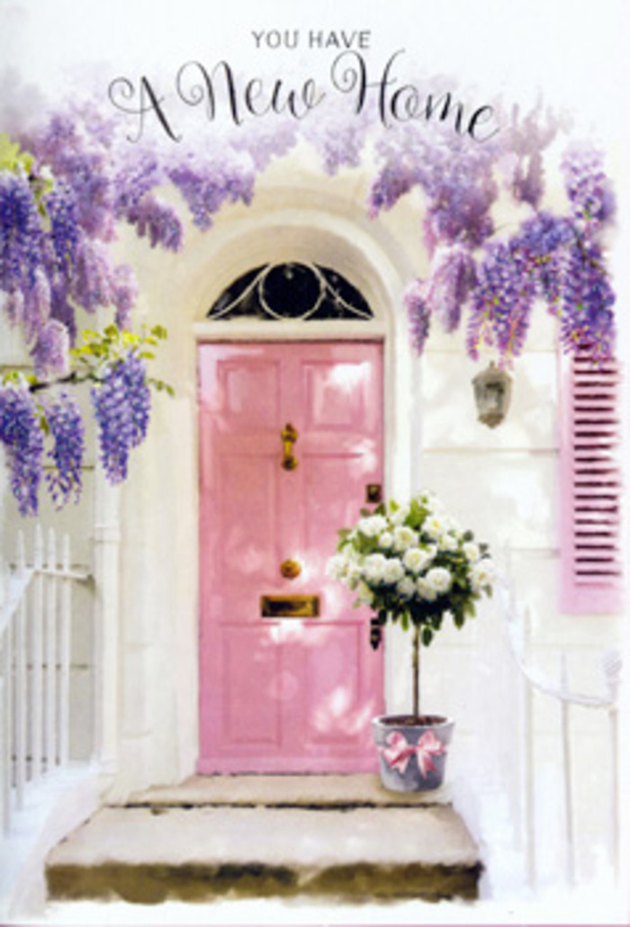Set against the calm charm of an Abbey Wood backdrop, this doorway vignette tells a story of new beginnings with tenderness and style. A soft pink door, painted in a beautifully even coat that gives it a silky, almost chalky finish, stands prominently at the centre. It is flanked by whitewashed walls whose subtle imperfections catch the daylight, creating small ripples of light and shade that add depth and texture. The entire entranceway is draped in lush wisteria, its long racemes of lavender and lilac blossoms tumbling down from above like a floral waterfall. Each cluster of flowers appears delicate yet abundant, together forming a fragrant veil that frames the door much like the blooms that might edge a garden close to Lesnes Abbey ruins. On the doorstep, a graceful floral arrangement completes the scene. A slightly rustic grey tin bucket, simple but elegant, is filled to brimming with white and cream roses. The roses themselves look sumptuous and refined: some petals tightly wrapped, promising to open in days to come, while others are fully unfurled, revealing swirling centres that invite the eye inward. Sprigs of soft, silvery-green foliage are woven among the blooms, giving the arrangement a natural, just-designed feel that speaks to the skill of a local Abbey Wood florist. Around the bucket, a blush-pink satin ribbon is tied in a soft bow, with its ends trailing down in relaxed, curling lines that mirror the hanging wisteria above. The overall mood is gentle, welcoming, and full of hope, ideal for celebrating a move to a new home, a first flat near the park, or a fresh chapter close to the heart of Abbey Wood.